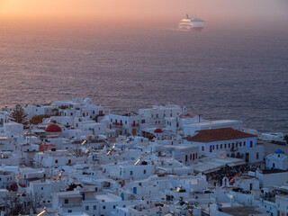 Fototapeta premium Mykonos sunset view in the Aegean Sea and Cruise Ship in Greece