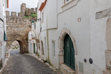 Obraz premium Estremoz old town street with ancient castle wall