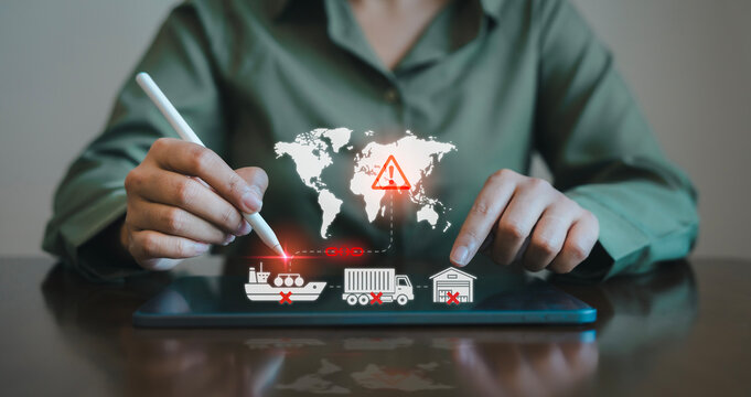 Person using stylus on tablet with virtual broken red supply chain and cancelled global logistics icons for Middle East conflict trade disruption concept