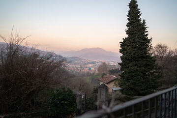 Fototapeta premium Golden sunset over Bergamo city with dramatic sky and historic skyline in Lombardy Italy.