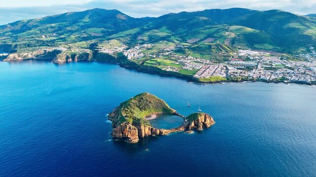 Dramatic volcanic rock formations and turquoise lagoon inside coastal islet near Vila Franca do Campo, drone footage