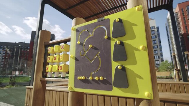Tic tac toe and children maze on modern playground in city park. Mind development games for little kids in apartment complex yard