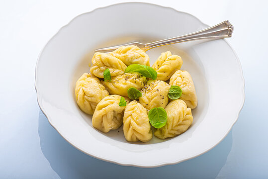 Culurgiones, typical ravioli of Sardinia. A first course of Sardinia: culurgiones or culugiornis, typical stuffed ravioli closed in an ear of wheat, best Sardinian culinary, pasta 