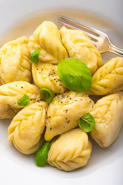 Culurgiones, typical ravioli of Sardinia. A first course of Sardinia: culurgiones or culugiornis, typical stuffed ravioli closed in an ear of wheat, best Sardinian culinary, pasta 