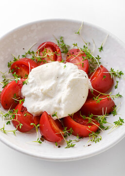 tomatoes with buratta cheese on a white background