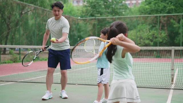 Happy family enjoying a lively game of tennis
