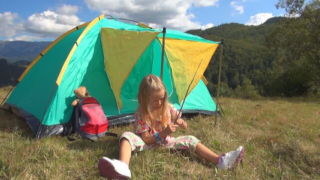 Child Playing on Meadow in Mountains, Girl by Tent in Trip, Landscape, Camping