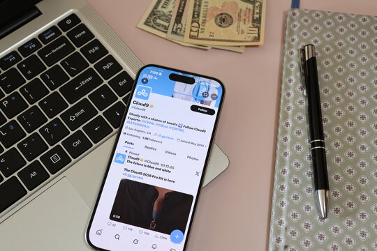 Kiel, Germany - 03-10-2026: X (Twitter) Profile of US esports organization Cloud9 displayed on smartphone lying on a laptop keyboard