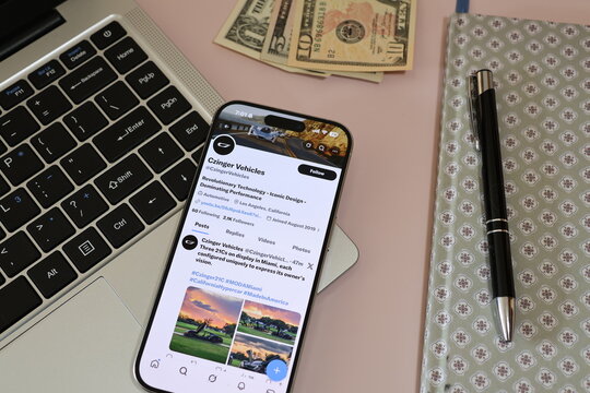 Kiel, Germany - 03-10-2026: X (Twitter) Profile of US automotive manufacturer Czinger Vehicles displayed on smartphone lying on a laptop keyboard