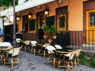 Cozy street with tables of cafe in quarter Montmartre in Paris, France. Architecture and landmarks of Paris. Postcard of Paris