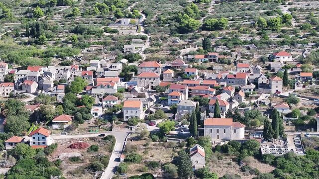 Drone aerial of Srednje Selo on Solta in Dalmatia Croatia, red rooftops.
