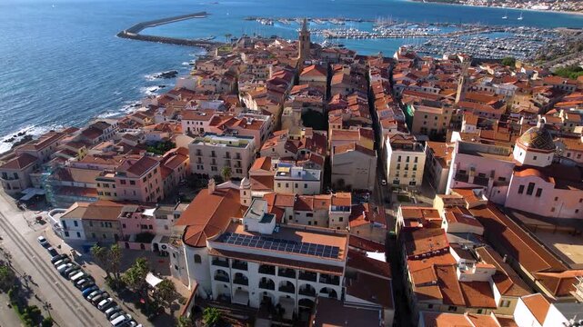 Alghero old town aerial view with Bell Tower and Cathedral dome over marina with yachts Sardinia Italy Mediterranean coast historic city architecture drone footage 4k travel destination