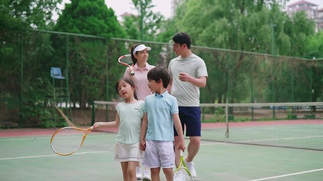 Happy family enjoying a lively game of tennis