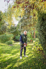 Fototapeta premium Active senior man doing yardwork