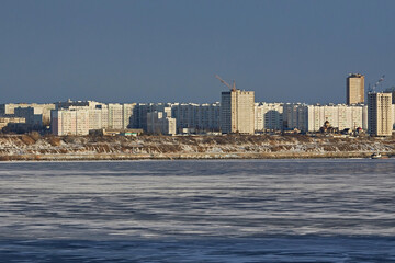 Naklejka premium City embankment with a frozen river