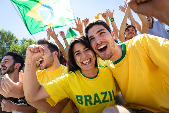 Brazil football fans cheering celebrating victory at stadium