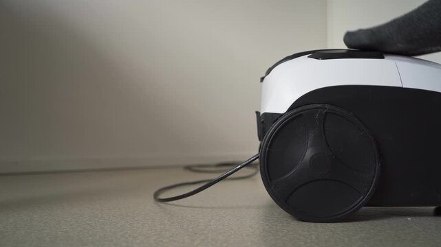 Using automatic power cord retraction on vacuum cleaner