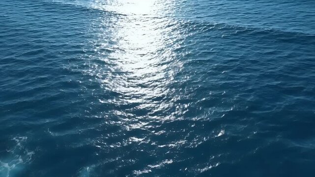 A direct aerial photograph captured from top-down perspective (bird's-eye view), showcasing the vast surface of the ocean, emphasizing its deep color, complex texture, and natural patterns