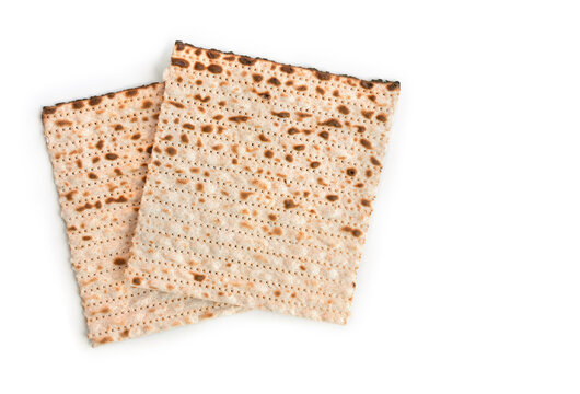 Two pieces of matzah for Passover celebration on white background with copy space. Top view, flat lay