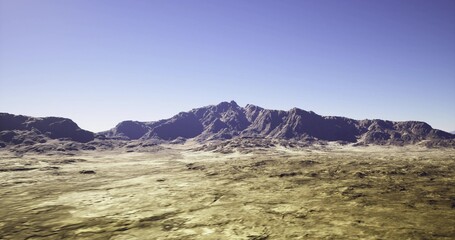 Fototapeta premium dramatic ridgeline over textured foreground, high contrast edges and long shadows evoke cinematic, rugged mood for adventure or production scouting