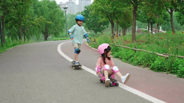 Happy kids skateboarding in the park