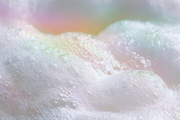 Fototapeta premium Soap foam bubbles iridescent pastel closeup texture frothy suds surface shimmering rainbow highlights with soft focus and delicate foam peaks