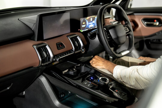 Modern car interior with digital dashboard, steering wheel and center console showing advanced automotive technology and premium design.