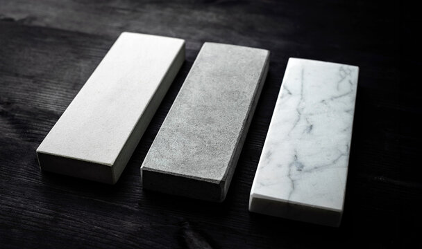 Three Sharpening Stones For Kitchen Knives On A Wooden Table