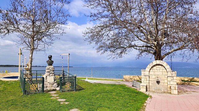 Photo of the bronze memorial bust of soldier Vassilis Rachoutis on the waterfront of Kamena Vourla town. Rachoutis is a national hero who perished saving others during the Express Samina shipwreck tra