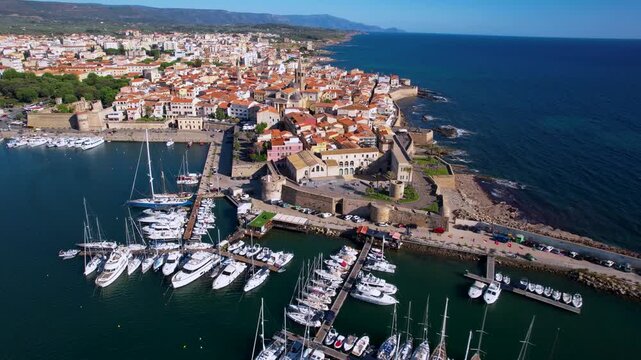 Sardinia Alghero aerial view of marina with sailing boats and old town walls Italy drone 4k travel destination Mediterranean seascape scenery
