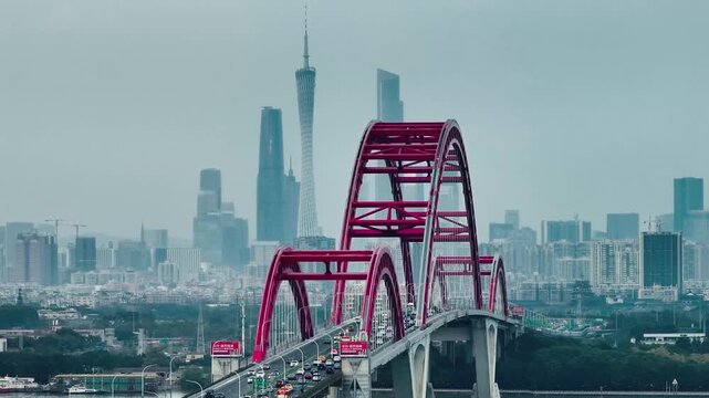 Filmed on January 1, 2025 in Guangzhou, Guangdong, China. A distinctive red arch bridge spanning the Pearl River, known for its unique wild goose shape.