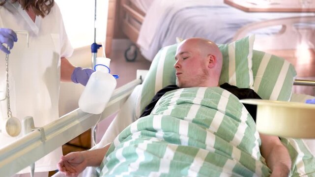 Nursing staff shows urinary aids to hospitalized young male patient explaining toileting assistance during care