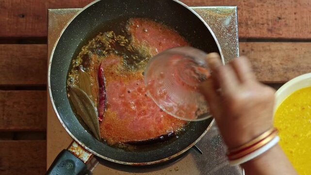 Traditional Indian Tempering Process with Spiced Tomato Puree in a Saut&eacute; Pan