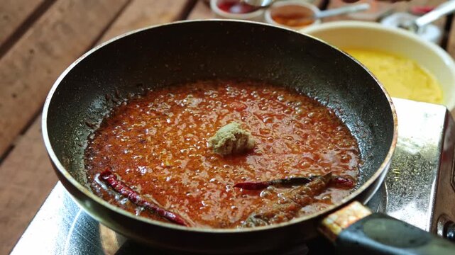 Authentic Bengali Macher Matha Diye Dal (Lentil Soup with Fish Head) being cooked in a pan.