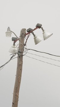 Sports field floodlights on wooden pole. vertical video