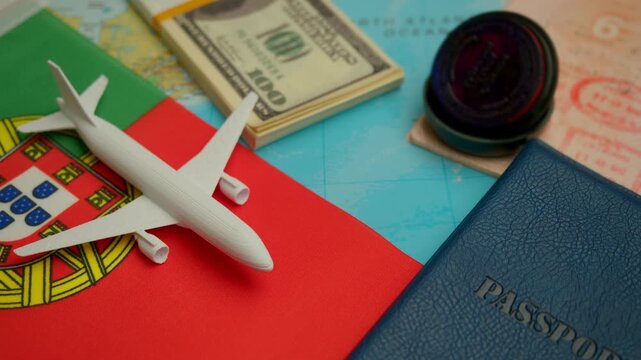 Airplane nears passport with Portugal flag and dollars scattered across map during international visa processing.