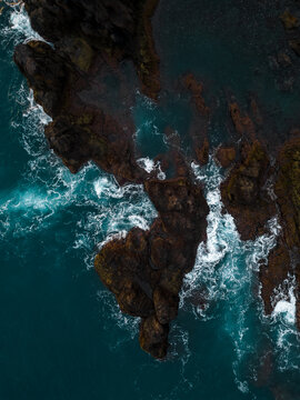 Aerial View of Waves Crashing on a Rocky volcanic Coastline, Madeira, Portugal