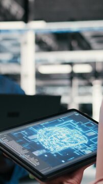 Vertical video Optimizing AI performance, devices and team of technicians in data center using deep learning. Brainstorming, neural network automation and software developers in data center, camera A