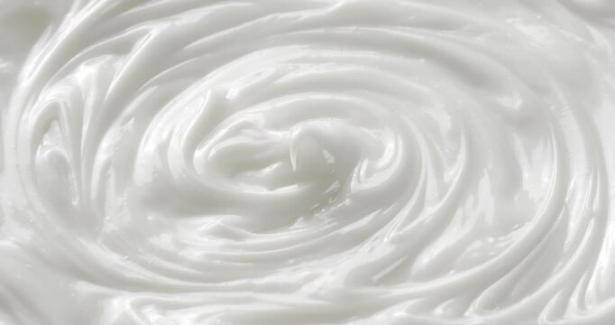 Cosmetic smears of creamy texture. Cosmetic skin cream. Beauty skincare product sample. Close-up footage of cream texture on rotating table