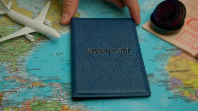 Passport with stamped visa on world map, plane and stamp emphasize flight theme.