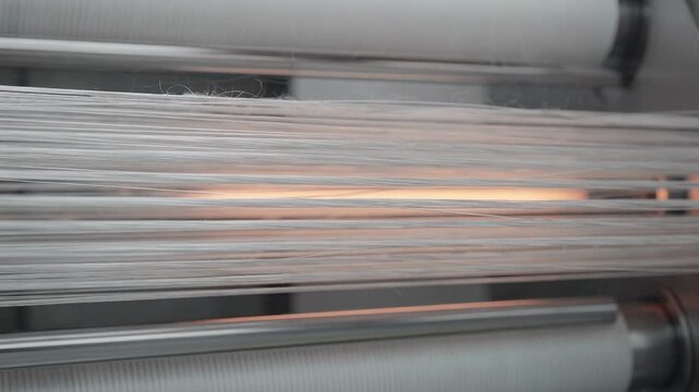 Medium shot of lowtow acrylic precursor fibers undergoing controlled oxidation process highlighting fine fiber detail and uniform stabilization before carbonization.