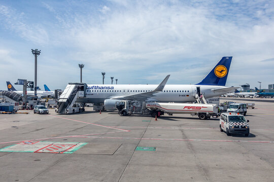 Lufthansa aircraft at the terminal of Frankfurt airport with panoramic view to apron and runway