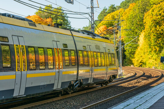 Partille, Sweden - October 11 2025: Closeup of modern regional train with reflections of autumn colors.