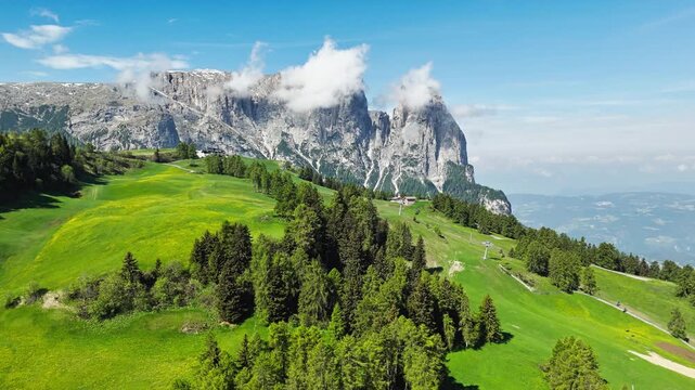 Alpe di Siusi or Seiser Alm meadows with a Dolomite rock massif in the background, aerial view. Summer alpine landscape in South Tyrol, Italy