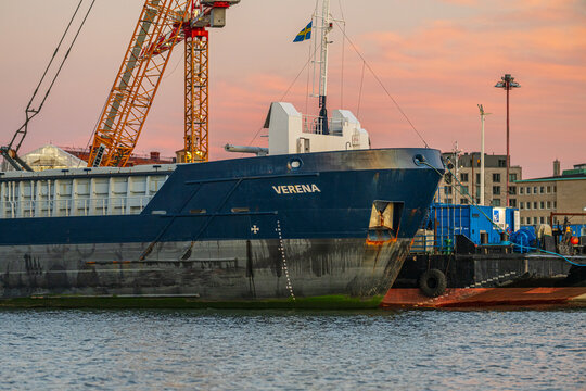 Gothenburg, Sweden - October 11 2025: Cargo ship Verena moored at dock during colorful sunset.