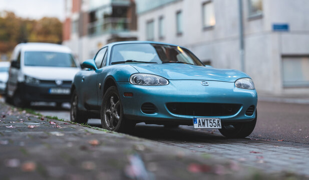 Gothenburg, Sweden - november 02 2025: Front view of blue Mazda MX5 Miata sports car parked on residential street.