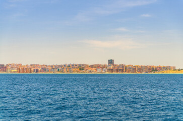 Costa Blanca White coast Mediterranean Sea water Bahia Alicante bay, Los Arenales del Sol town with buildings and beach coastline, Els Arenals del Sol city in summer day, Valencian Community, Spain