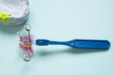 Orthodontic plate with screw and tightening keys. A tool for expanding the upper jaw in a child. © dore art