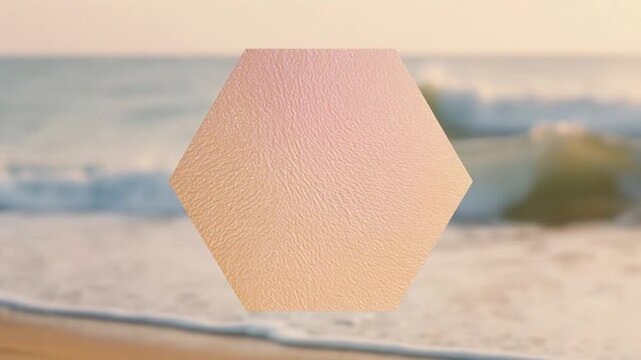 Hexagonal shape on beach with waves and island in the background