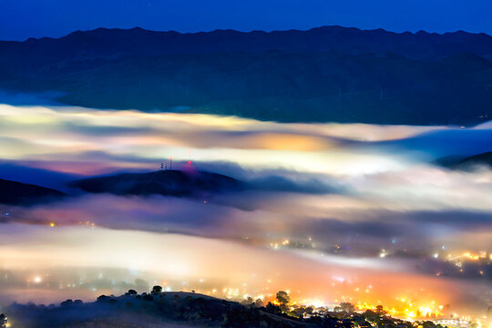 Night light from view of city and lights with fog and cloud inversion